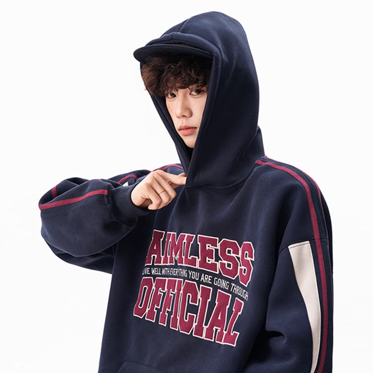 Person wearing a navy hoodie with red and white text on a white background