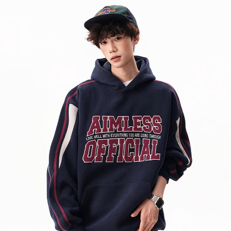 Person wearing a navy hoodie with 'AIMLESS OFFICIAL' text on a white background