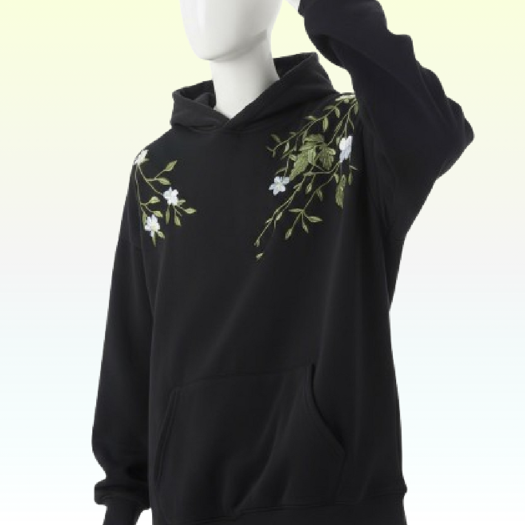 Black hoodie with floral embroidery on a mannequin against a light green background